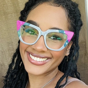 Close-up of retro cat-eye glasses with ivory and floral color-blocking on a model