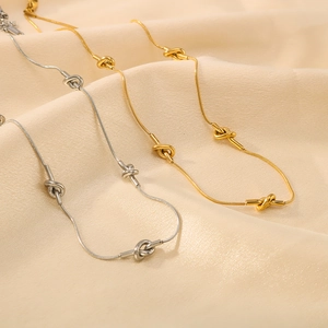 Asymmetric geometric knot necklaces in gold and silver finish with sleek snake chains