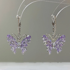 Sparkling butterfly earrings with purple and white zircon crystals on silver metal