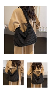 Detail of black corduroy tote bag showing ribbed texture and casual commuter style