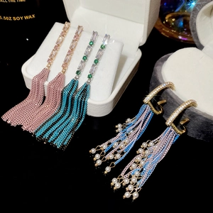 Detail of elegant tassel earrings with sparkling rhinestones and delicate faux pearls