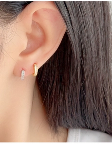Close-up of minimalist S925 silver and gold square zircon hoop earrings on a model