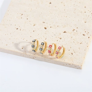 Golden huggie hoop earrings with zircon evil eye and red black enamel charms