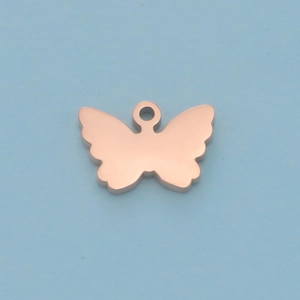 Macro view of a rose gold butterfly charm pendant with a polished mirror finish surface
