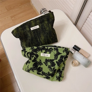 Detail of vintage floral jacquard toiletry bags with a simple wish brand label