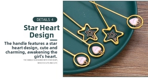 Detail of golden stainless steel stirring spoon with a pink heart pendant and Love engraving