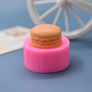 Pink silicone macaron mold for DIY candles and handmade soap making with textured finish