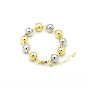 Detail of mixed gold and silver polished beads on a 18k plated bracelet with lobster clasp
