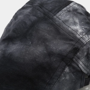 Macro shot of vintage tie-dye cotton fabric and double-needle stitching on the cap
