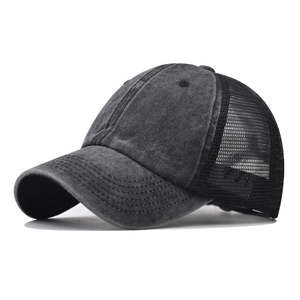 Deep grey washed cotton trucker hat with breathable mesh back in a 45-degree side view