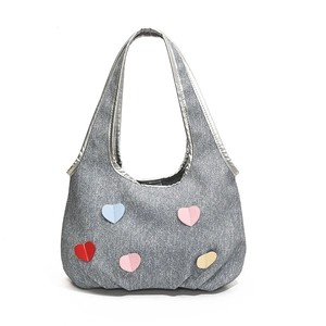 Gray denim tote bag with colorful heart patches and metallic silver trim for casual style