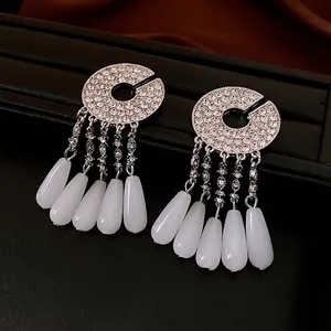Silver fringe drop earrings with sparkling crystals and white teardrop pendants