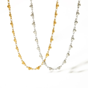 French vintage 18K gold and silver heart chain necklaces in a minimalist layout