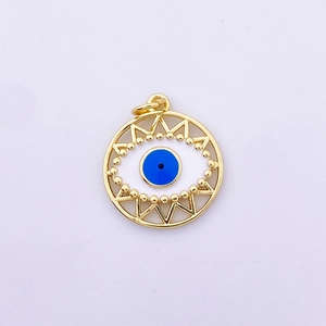 Macro detail of golden Evil Eye charm with blue enamel inlay and geometric textured edges
