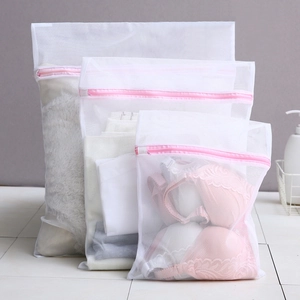 Set of various sized white mesh laundry bags with pink zippers for washing delicate clothes