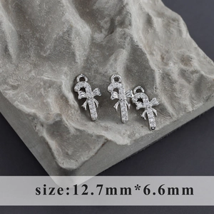 Detail of candy cane charms with rhodium plating and white zircon bow accents