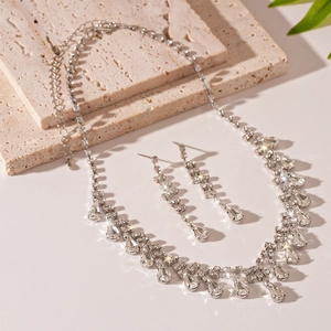 Macro shot of silver water-drop jewelry set with sparkling crystals on stone