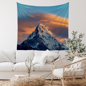 Detail of bohemian tapestry featuring a vibrant sunset over mountains in a modern living room