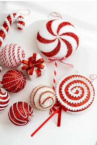 Detailed view of festive red and white candy cane ornaments with glitter and velvet bows