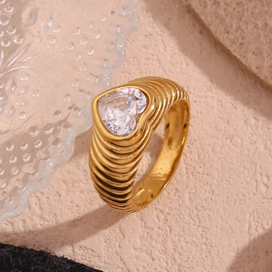 Macro detail of 18K gold plated ring featuring a heart-shaped zircon and wave patterns