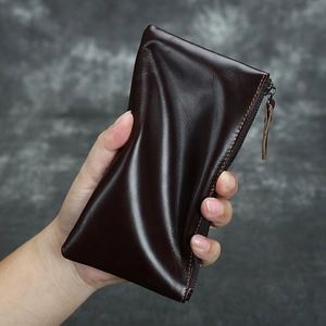 Close-up of deep brown crazy horse leather wallet showing natural grain and zipper detail