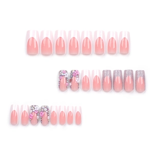 French press-on nails with nude pink base, white tips, 3D flowers, and pearl accents