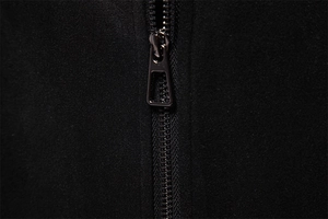 Detail of high-quality dark gunmetal zipper on black suede jacket with trapezoid slider