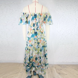 Detail view of colorful polka dot off-shoulder dress with a tiered cake skirt
