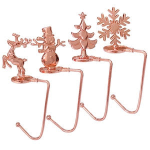 Set of four rose gold Christmas mantel hooks featuring reindeer snowman tree and snowflake
