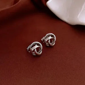 Minimalist silver entwined hollow hoop earrings with a textured knot design for women