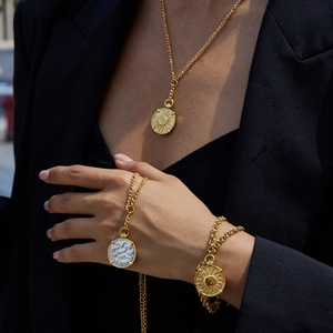 Retro titanium steel jewelry set featuring sun totem coin pendants on necklaces and bracelets