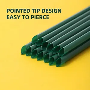 Deep green plastic drinking straws with sharp slanted tips on a bright yellow background