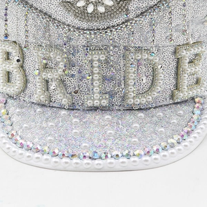 Macro view of bride hat with silver sequins, pearl bride letters and crystal fringes