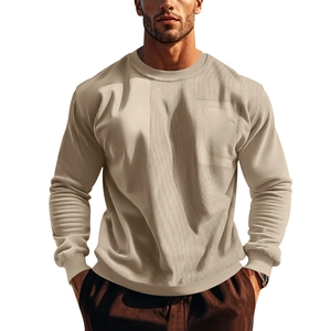 Detail of men's crewneck sweatshirt featuring corduroy patchwork and a chest pocket