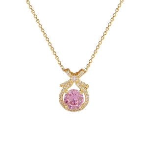 Elegant gold-tone titanium necklace with pink round gemstone and pavé bow pendant