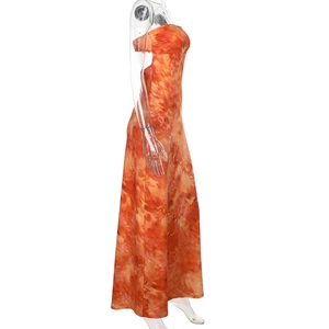 Detail of slim fit tube top maxi dress with orange-red tie-dye print and elastic fabric