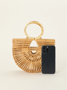 Macro detail of natural bamboo texture and hand-woven hollow design on a semi-round handbag