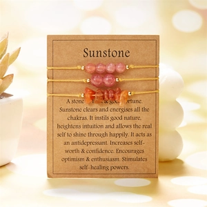 Detailed set of three sunstone bracelets with beads and raw stones on a gift card