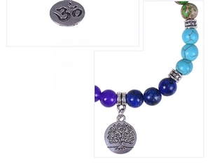 Detailed macro view of seven chakra stone beads and antique silver tree of life charm