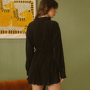 Women's black pleated long-sleeve midi dress with tie waist and elegant back view