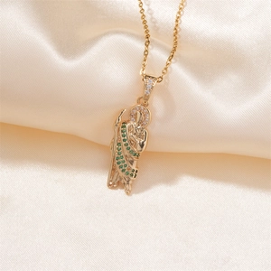 Gold religious saint pendant necklace with green and white zircons on beige silk