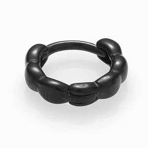 Macro detail of black stainless steel hoop earring with industrial chain link texture