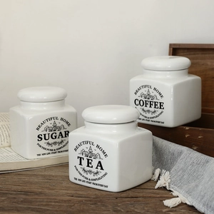 Minimalist white ceramic storage jars for tea coffee and sugar in Nordic style