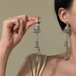 Detail of silver vintage ethnic triple-layer Jhumka earrings with tassel beads