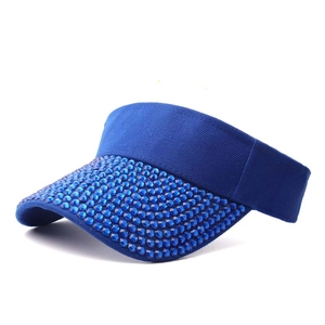Detail of royal blue sun visor with dense rhinestones on twill fabric for women