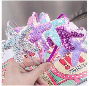 Detail of glittery starfish headbands in various colors like silver, pink, blue and purple