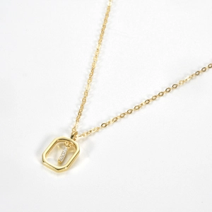 Macro shot of gold-plated S925 sterling silver rectangle pendant necklace with crystals