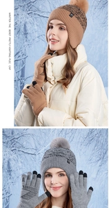 Close-up of winter knit beanie with pompom and touch-screen gloves set in tan and grey