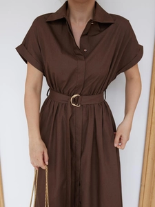 Detail of coffee cotton shirt dress with turnover collar and gold D-ring belt buckle