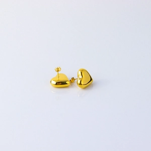 Close-up of polished 18K gold-plated irregular heart stud earrings on a white surface